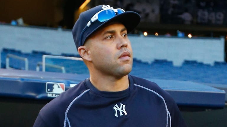 Yankees rightfielder Carlos Beltran comes out from the dugout for...