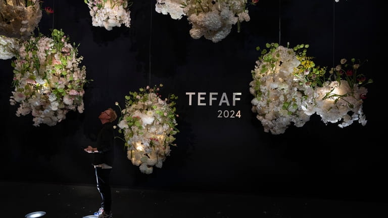 A man looks at floral decorations at the European Fine...