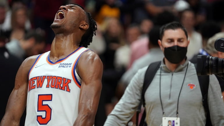Knicks guard Immanuel Quickley screams after his team defeated the Heat...