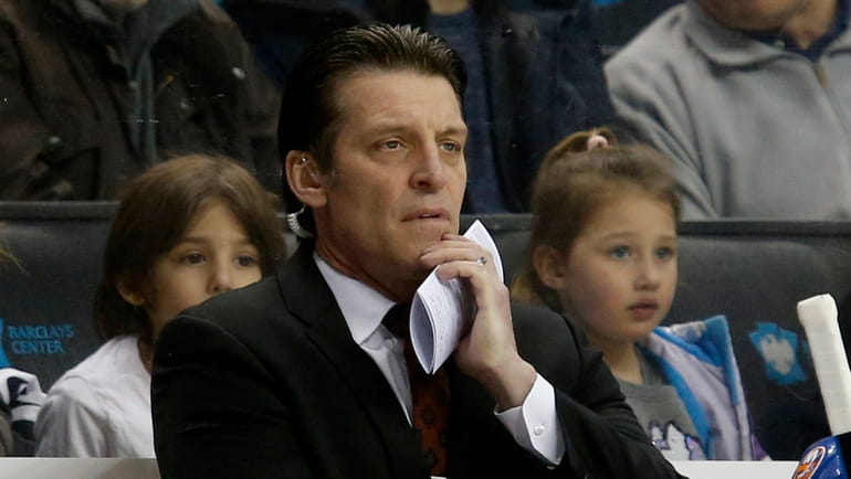 Assistant coach Lane Lambert of the New York Islanders behind...