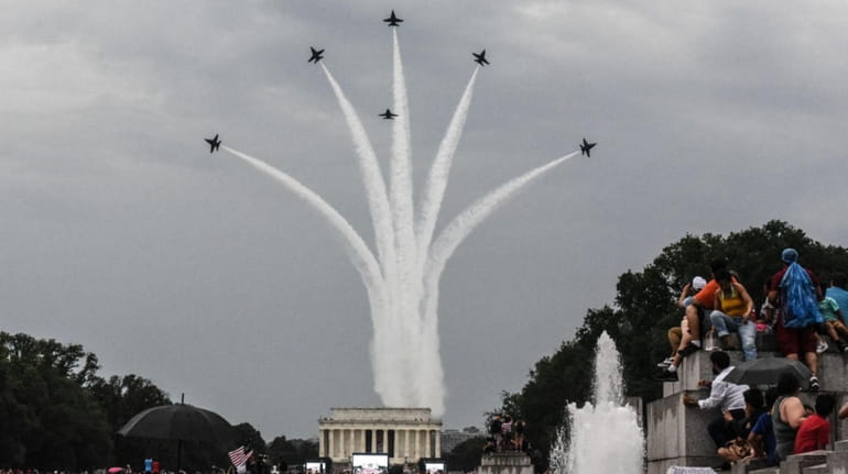 People react to a military flyover on the National Mall...