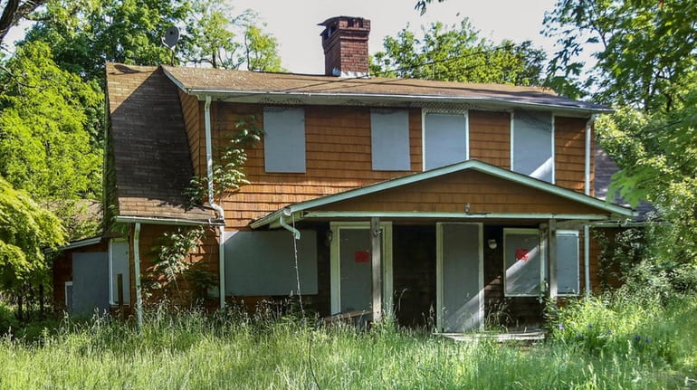 Port Jefferson officials are considering tearing down this vacant house...