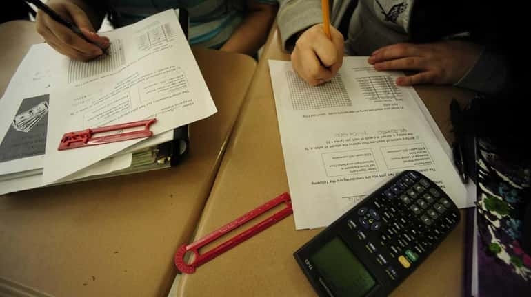 Students work on a problem together in the ninth-grade integrated...