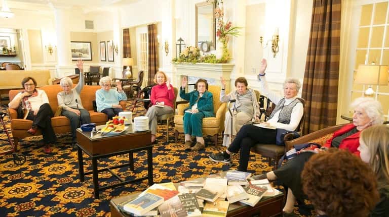 Residents participate in the book club led by Lynda Aron...