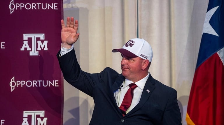 Newly appointed Texas A&M head coach Mike Elko waves during...