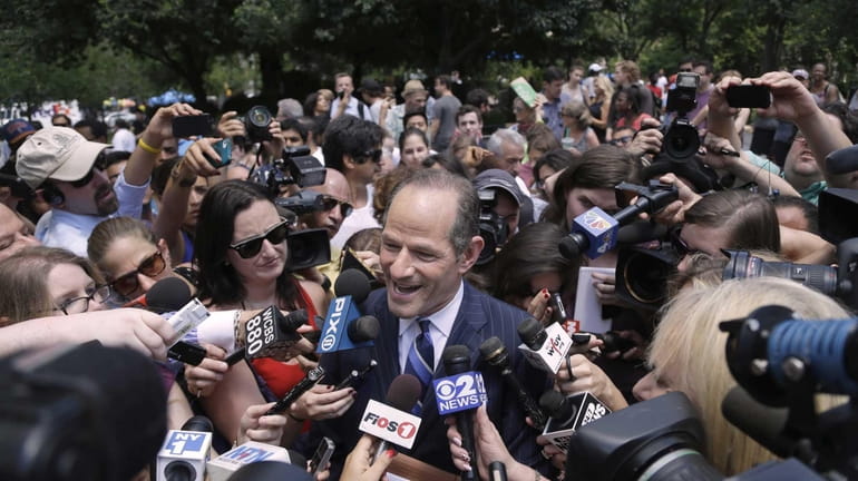 Former New York governor Eliot Spitzer is surrounded by media...