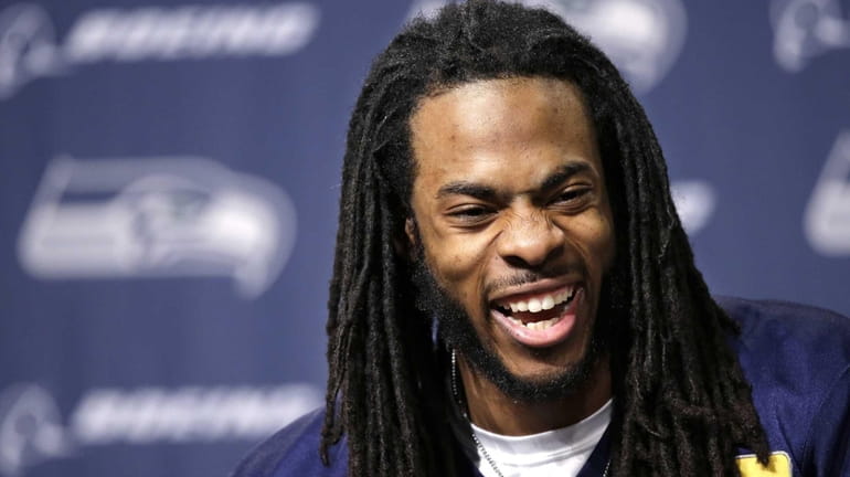 Seattle Seahawks' Richard Sherman laughs as he speaks during a...
