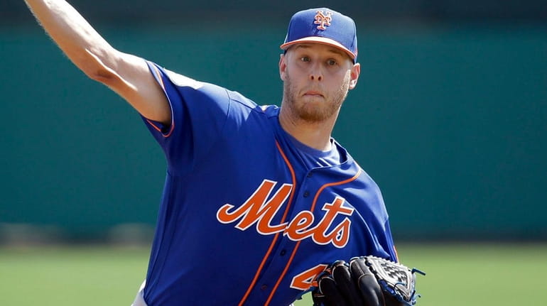New York Mets starting pitcher Zack Wheeler throws in the...