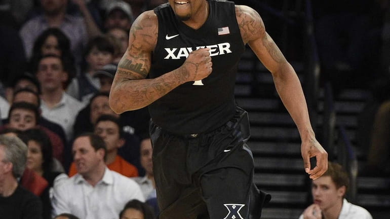 Xavier Musketeers forward Jalen Reynolds reacts after he scores against...