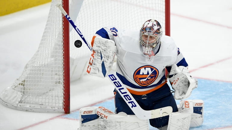 New York Islanders goaltender Semyon Varlamov defends the net against the...