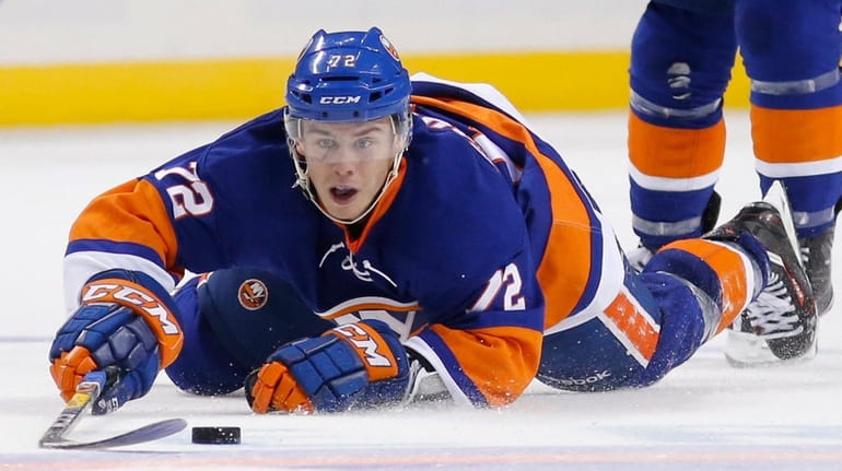 New York Islanders left wing Anthony Beauvillier tries to control...