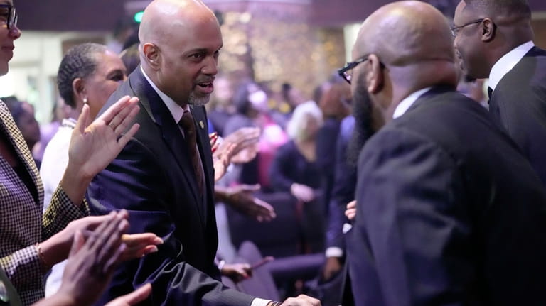 Clayton Harris, candidate for Cook county state's attorney, greets church...