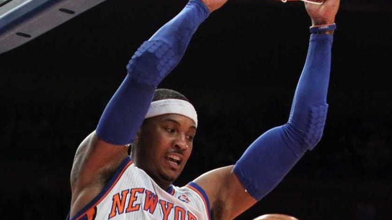Carmelo Anthony #7 of the New York Knicks dunks against...