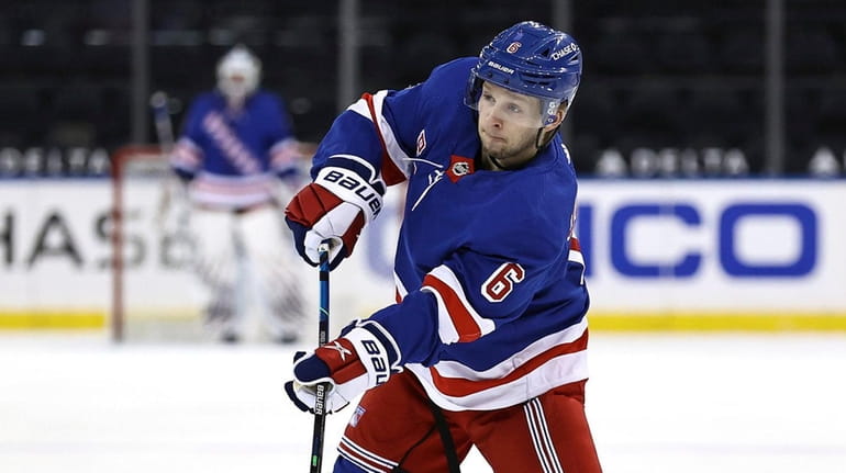 Rangers' Zac Jones passes the puck during a power play...