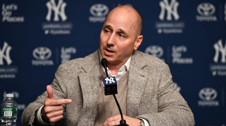 Brian Cashman answers questions during a news conference at Yankee...