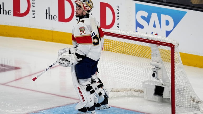 Florida Panthers goaltender Alex Lyon (34) looks down ice after...