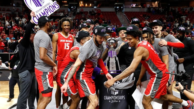 New Mexico players celebrate after defeating San Diego State in...