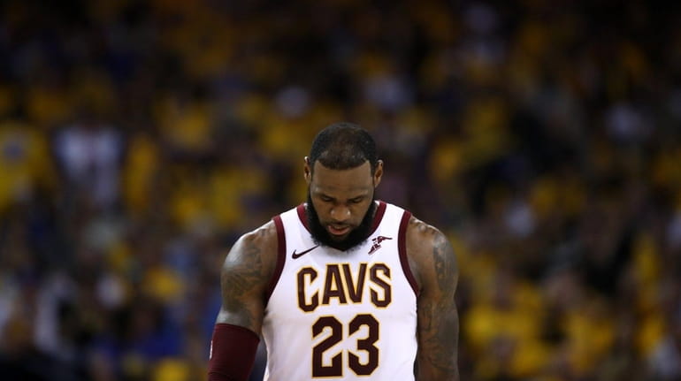 LeBron James #23 of the Cleveland Cavaliers reacts against the...
