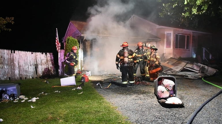 Firefighters at the scene of a house fire late Thursday night in...