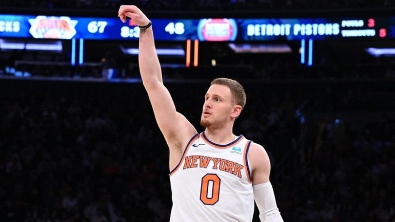 Knicks guard Donte DiVincenzo follows through on a three-point basket...