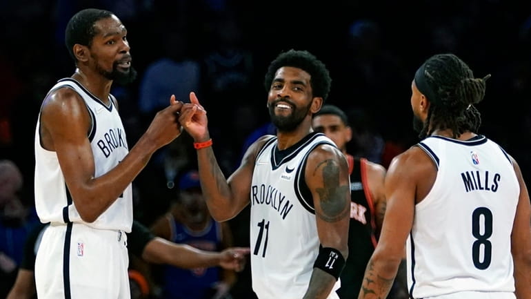 Nets' Kevin Durant, left, and Kyrie Irving (11) celebrate with...