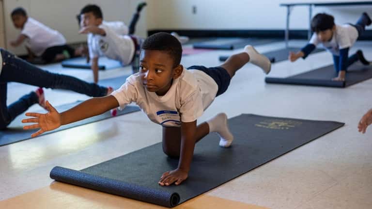 Summer stretch: Students in a yoga class at Westbury Middle...