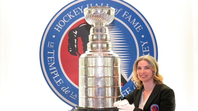 Cup Keeper Miragh Bitove is photographed with the Stanley Cup...