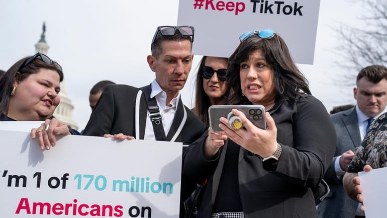 Devotees of TikTok monitor voting at the Capitol in Washington,...