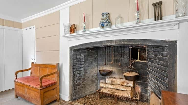 It features a central chimney and a fireplace with a...
