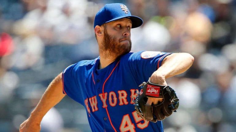 Mets pitcher Zack Wheeler delivers in the first inning of a...