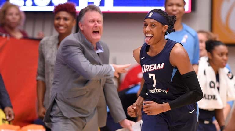 Dream guard Brittney Sykes reacts after she scored during the...