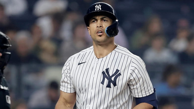 Giancarlo Stanton #27 of the Yankees strikes out to end...