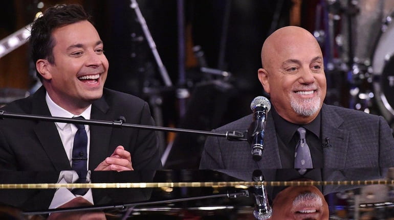 Billy Joel, right, and Jimmy Fallon perform together during Joel's...