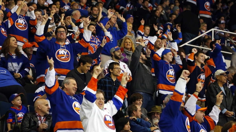 New York Islanders fans cheer after a second period goal...