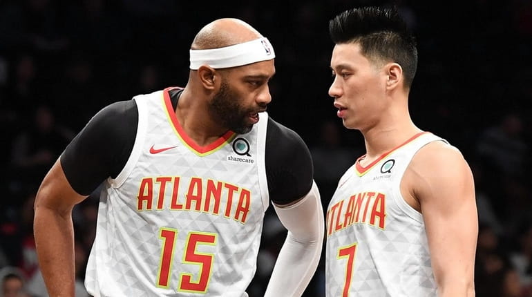 The Hawks' Vince Carter and Jeremy Lin talk during a...