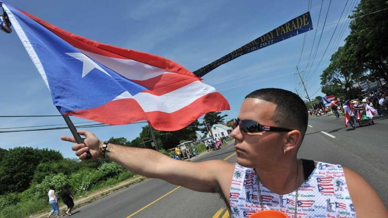 Joseph Alonso of Bay Shore waves his Puerto Rican flag...