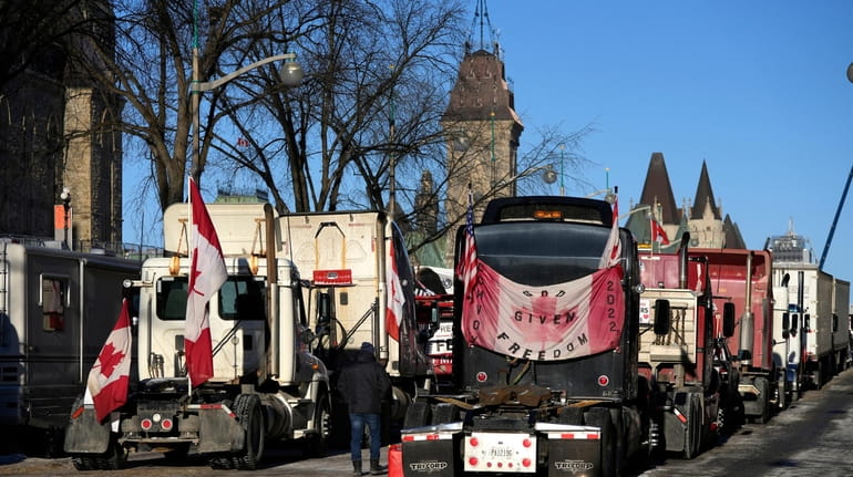 Trucks line a street in Ottawa on Monday as the...