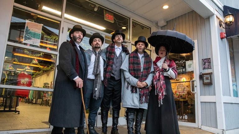 The Connecticut Carolers sing on at the Dickens Festival on...