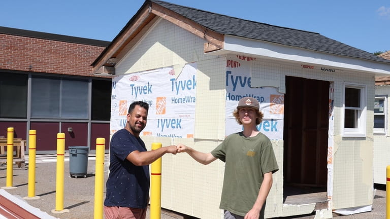 Finnias Wilson, 17, helped build this shed with Benny Diaz, building...
