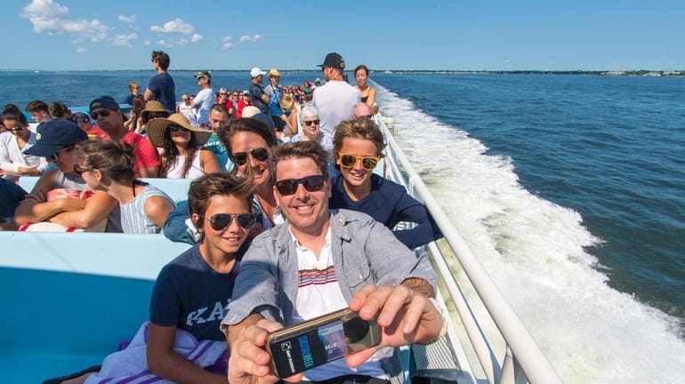 Brian Shea Larchmont takes a selfie with his family aboard...