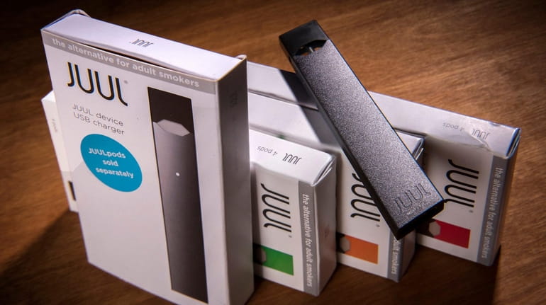 A Juul vaping system with accessory pods in various flavors.