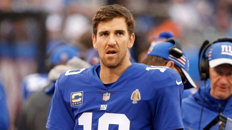 Eli Manning #10 of the Giants looks on from the sidelines...
