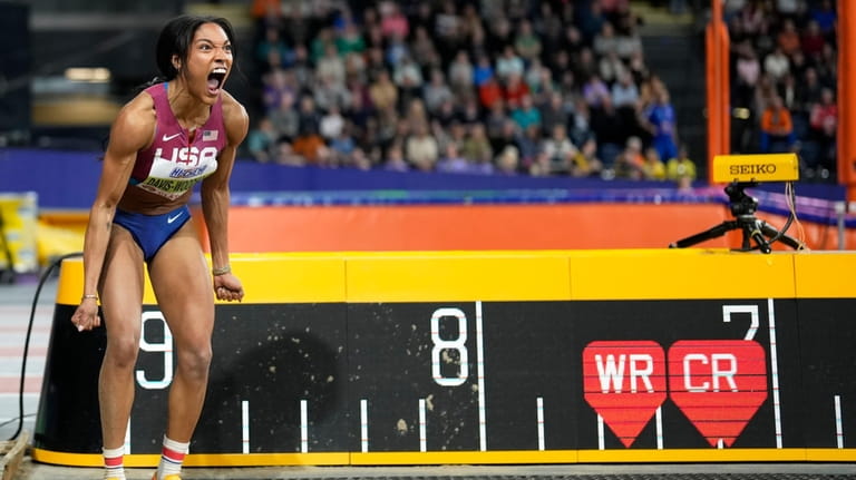 Tara Davis-Woodhall, of the United States, reacts after an attempt...