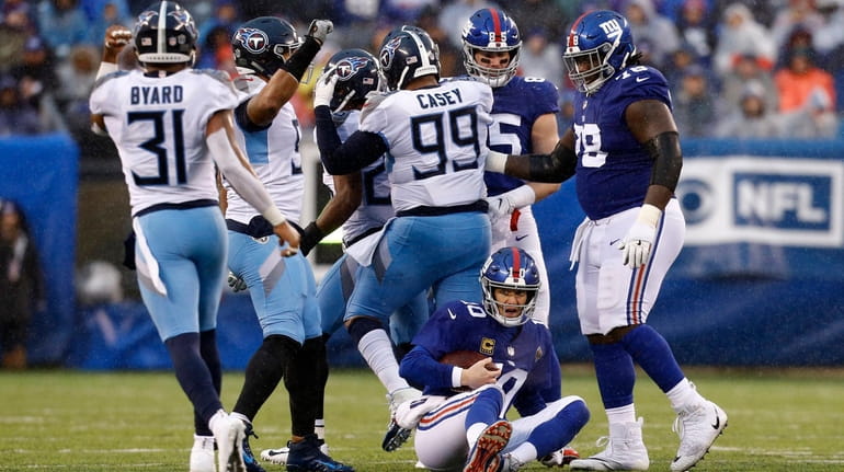 Giants quarterback Eli Manning looks on after being sacked by the...