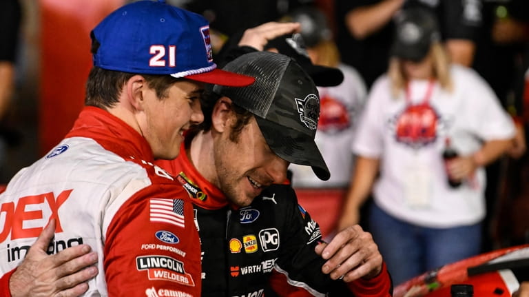Ryan Blaney, right, is embraced in Victory Lane by Harrison...