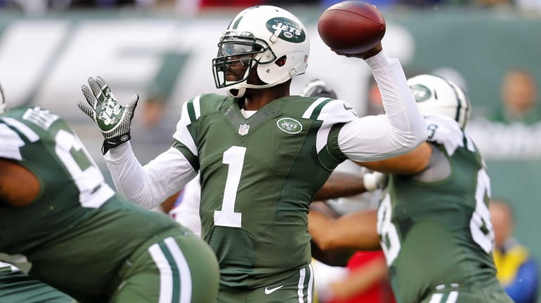 Michael Vick of the Jets throws a pass in the...