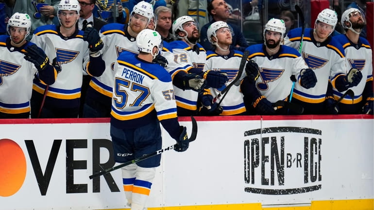 St. Louis Blues left wing David Perron (57) is congratulated...