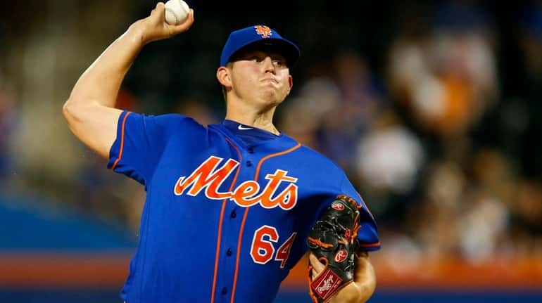 Chris Flexen of the Mets pitches in the first inning...