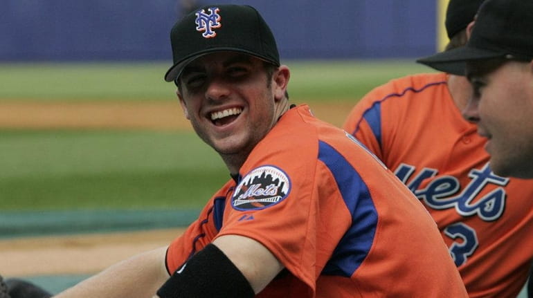 David Wright, left, jokes with Ty Wigginton while stretching before...