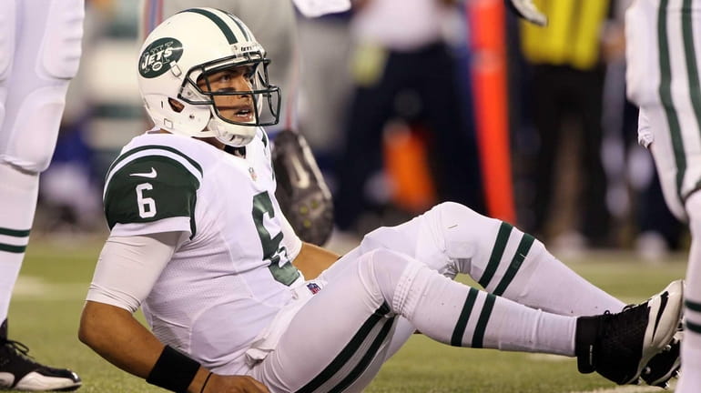 Mark Sanchez looks on after he was sacked for the...